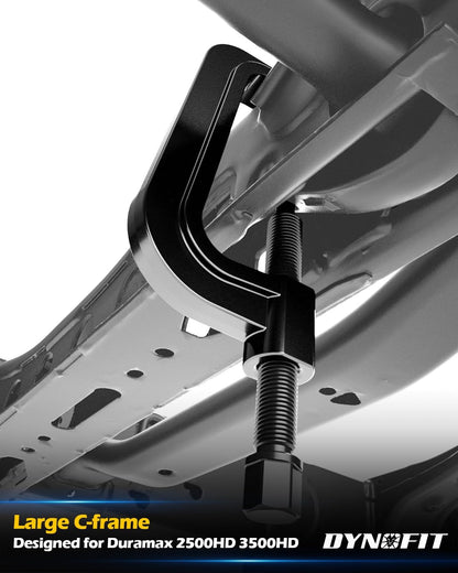 Large C-frame torsion key removal tool installed on Duramax 2500HD 3500HD undercarriage for unloading.